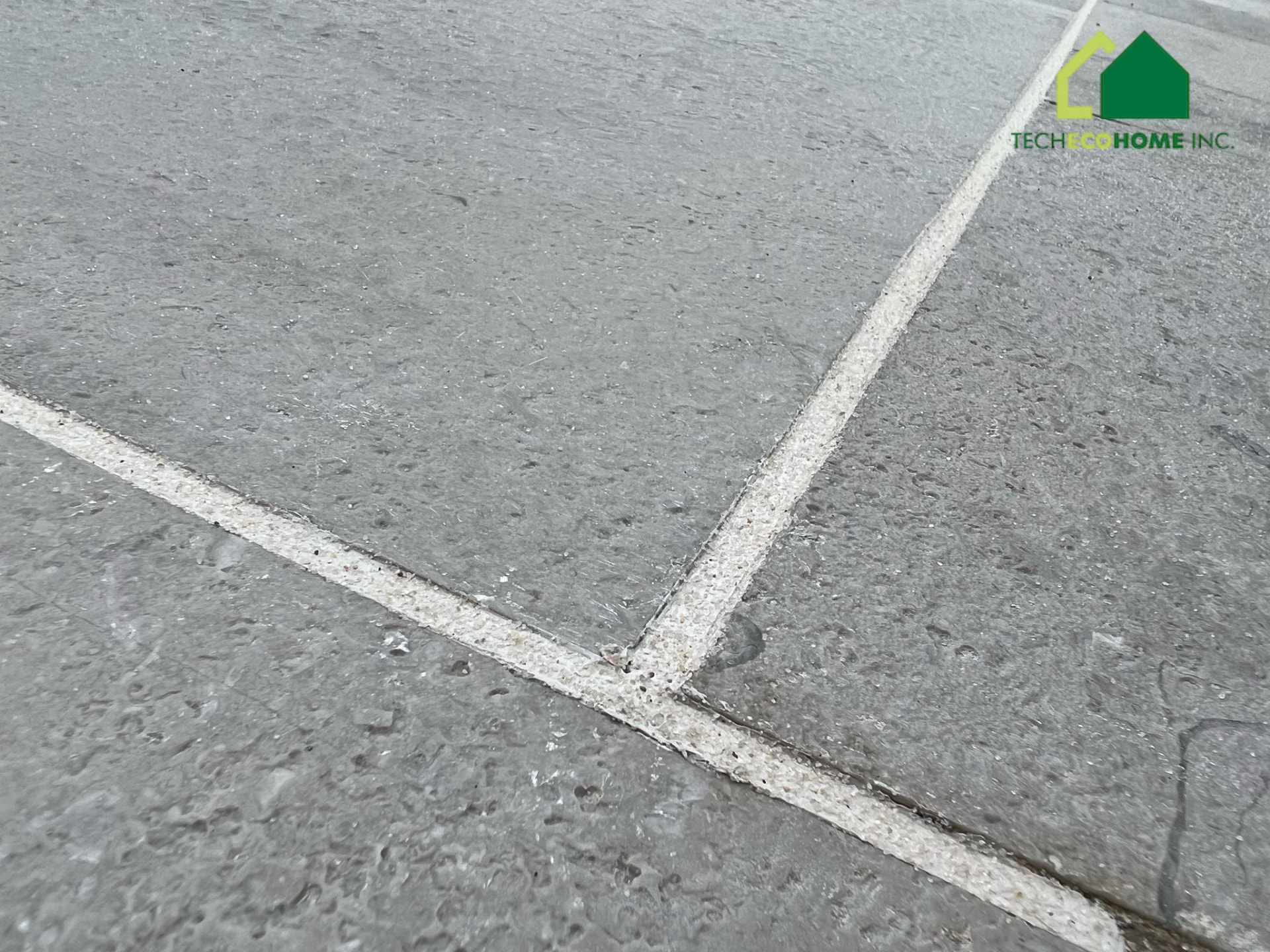 Sealed control joints forming a clean corner on a concrete slab