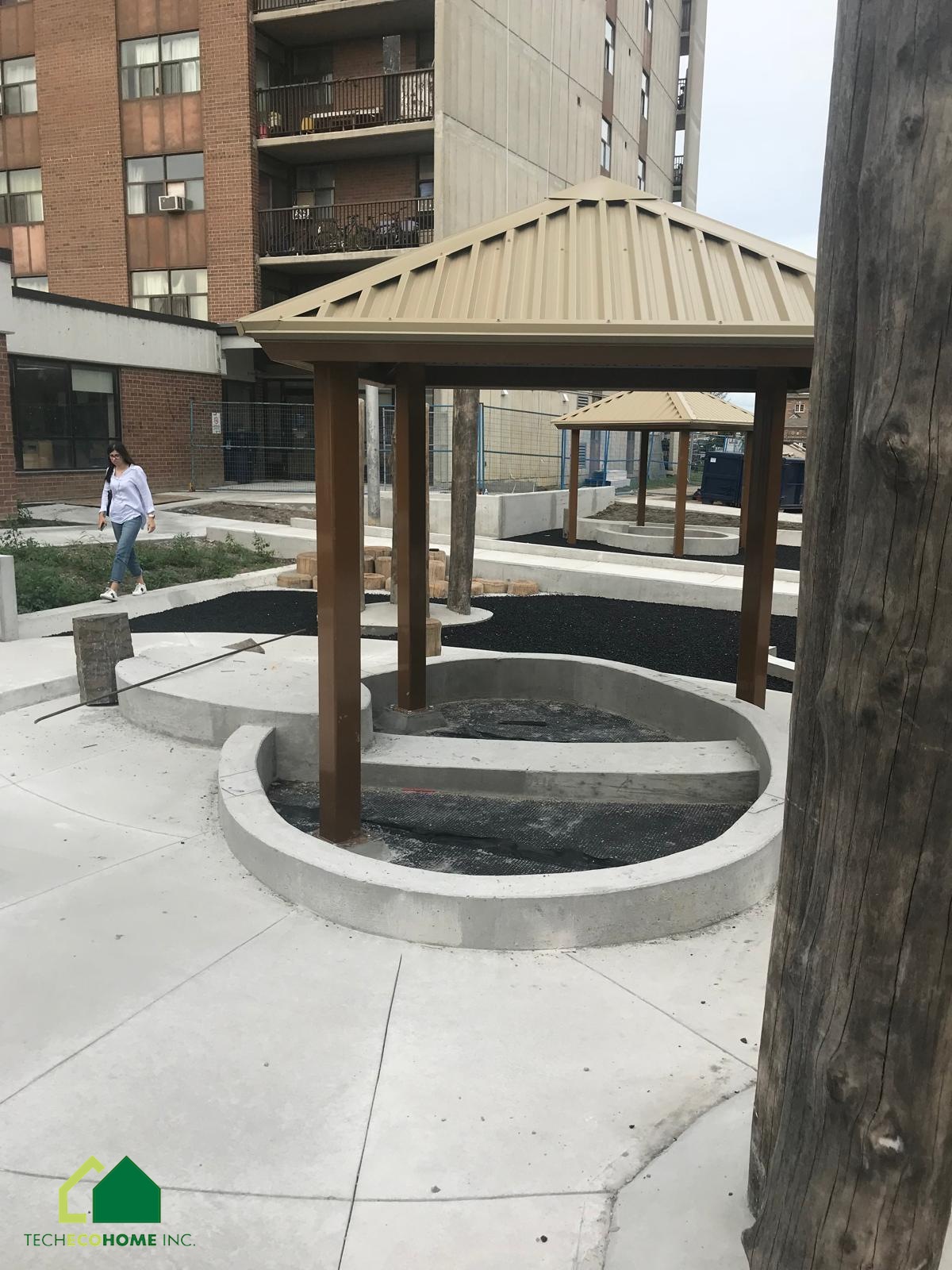 Curved concrete wall and gazebo base under construction