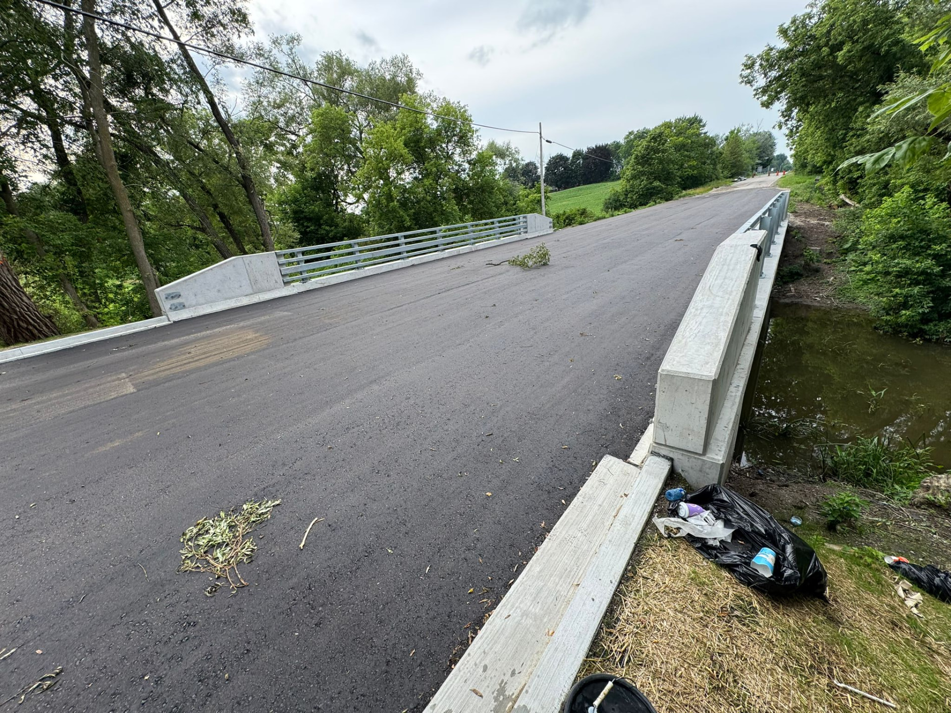 Completed bridge deck with concrete barrier walls and galvanized railing